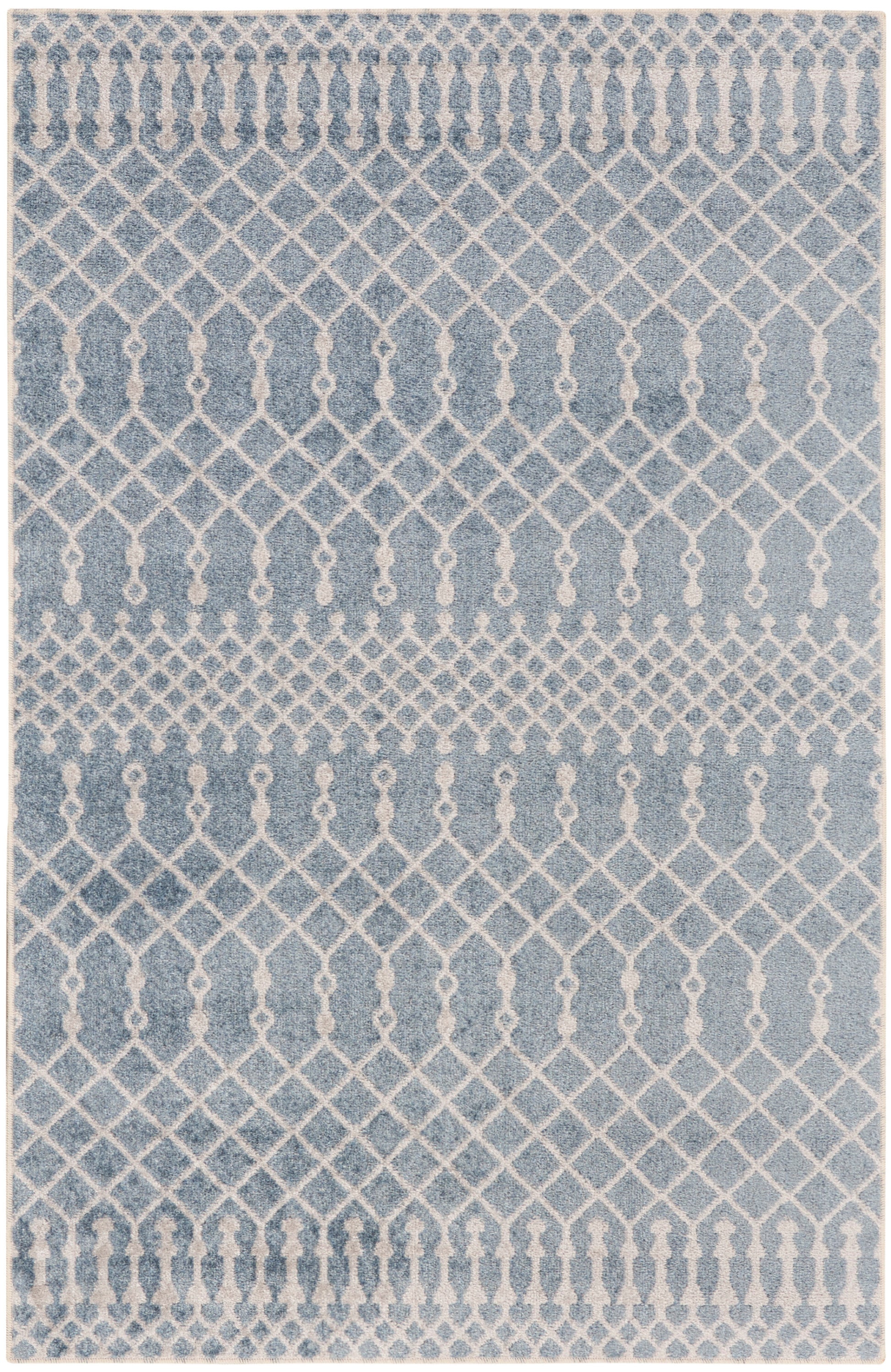 Blue rug with ivory lattice and diamond trellis pattern; distressed finish for contemporary living room decor.