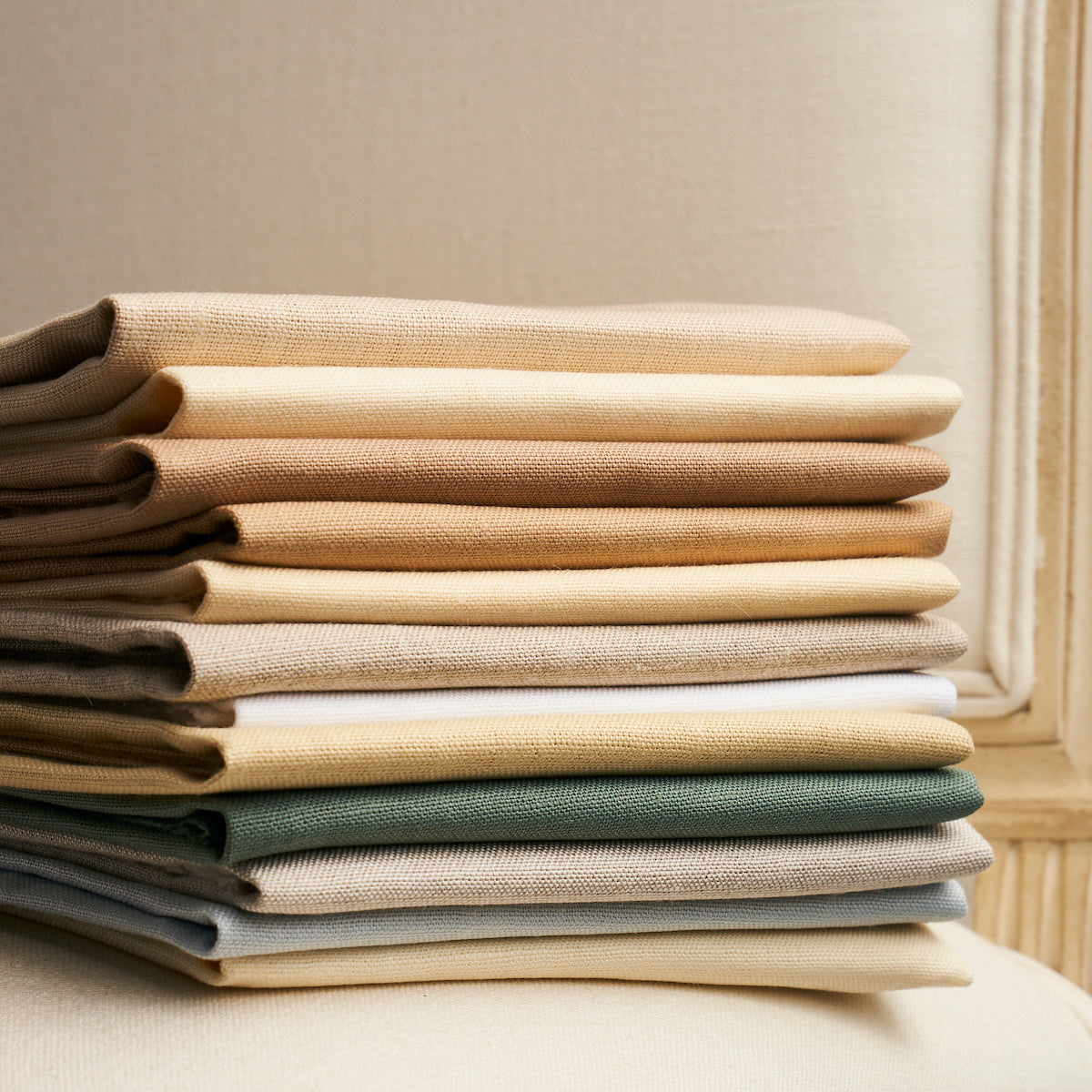Stack of folded ivory linen plains fabric