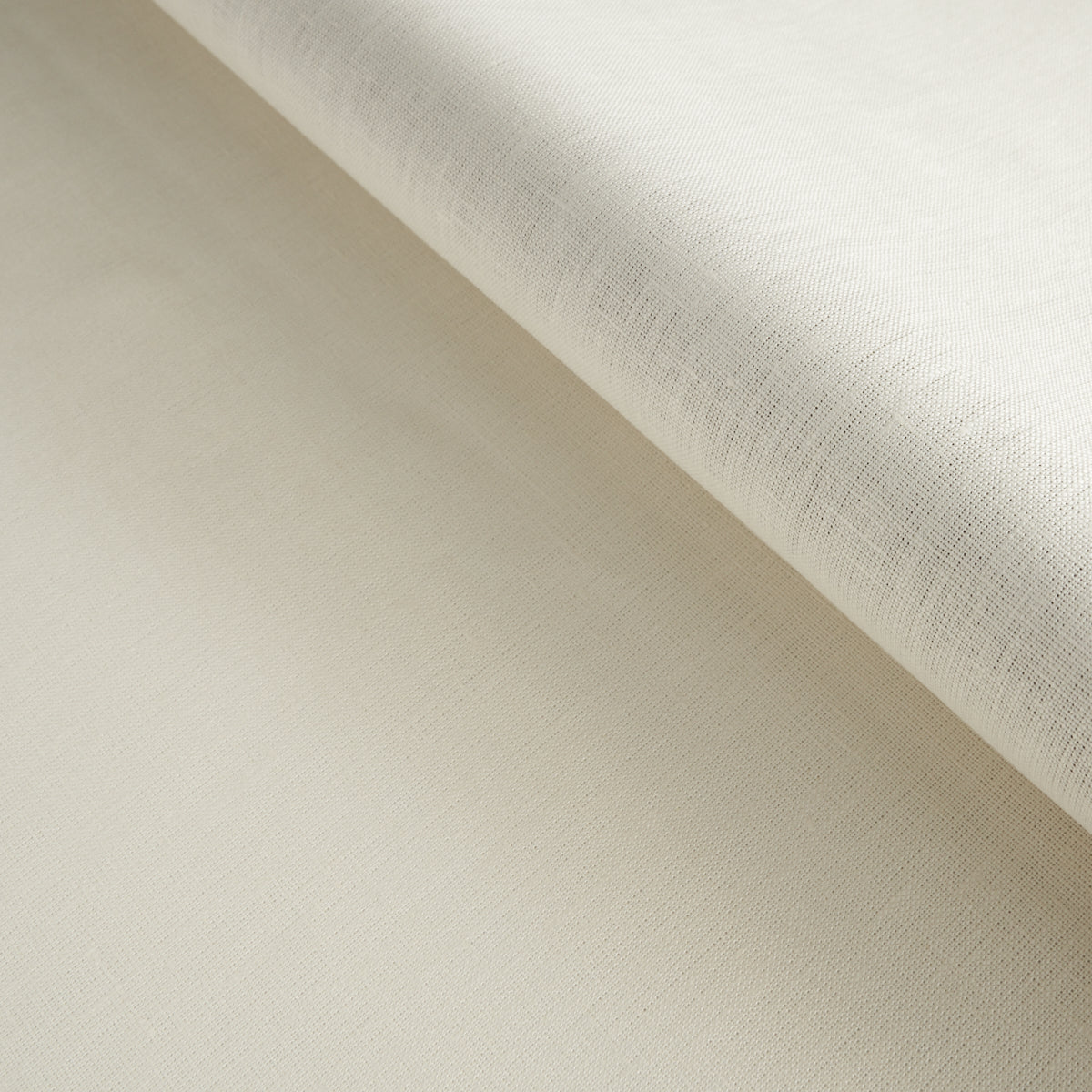 Cream linen fabric roll with soft texture; neutral beige textile for sewing, drapery or apparel.