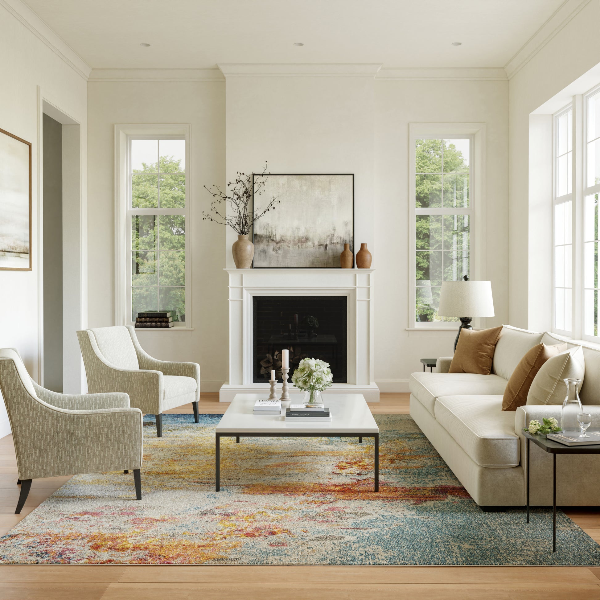 Bright living room with cream sofa, beige armchairs, white fireplace, glass coffee table, colorful rug, large windows.