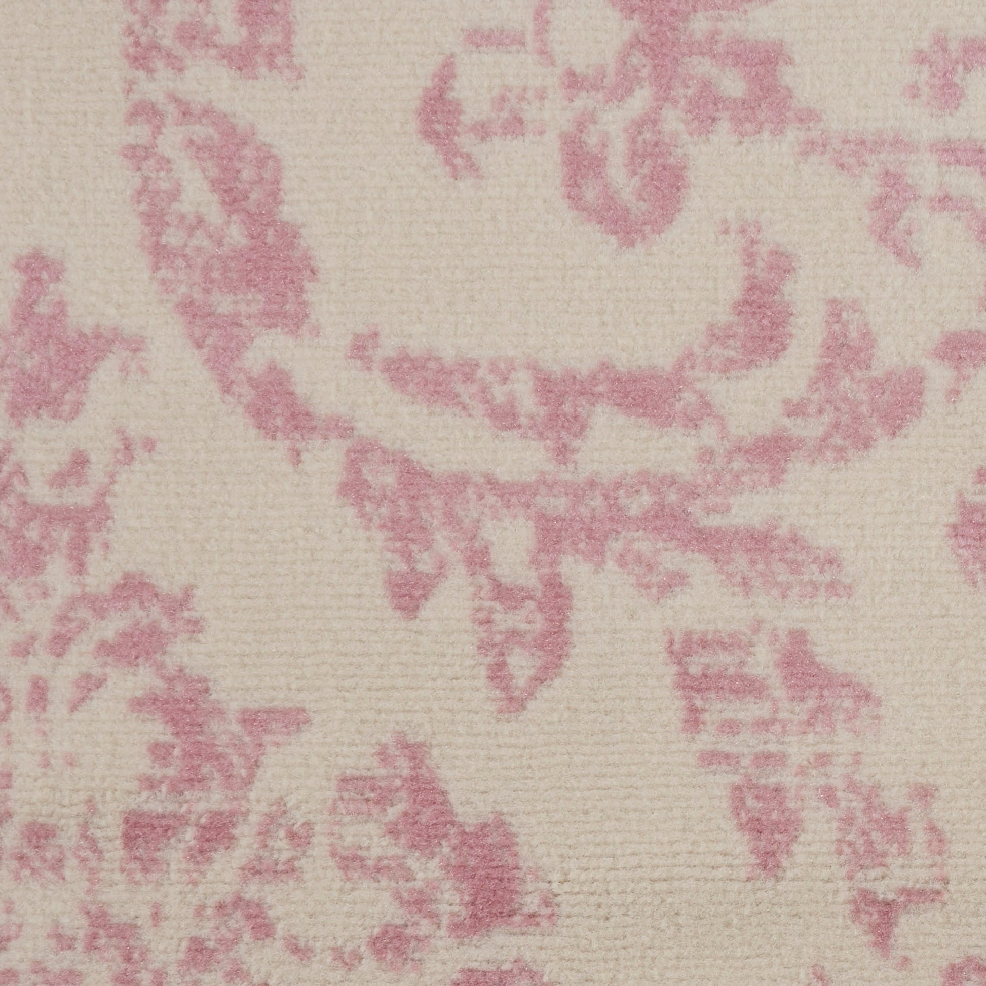Cream rug with pink damask floral pattern, round vintage-style rug.