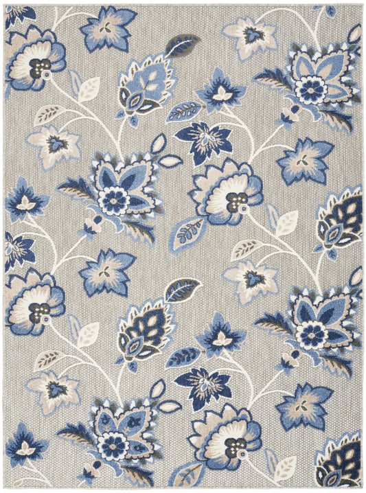 Rectangular beige woven area rug (5' x 8') with blue, navy, and white floral pattern; decorative botanical motif.