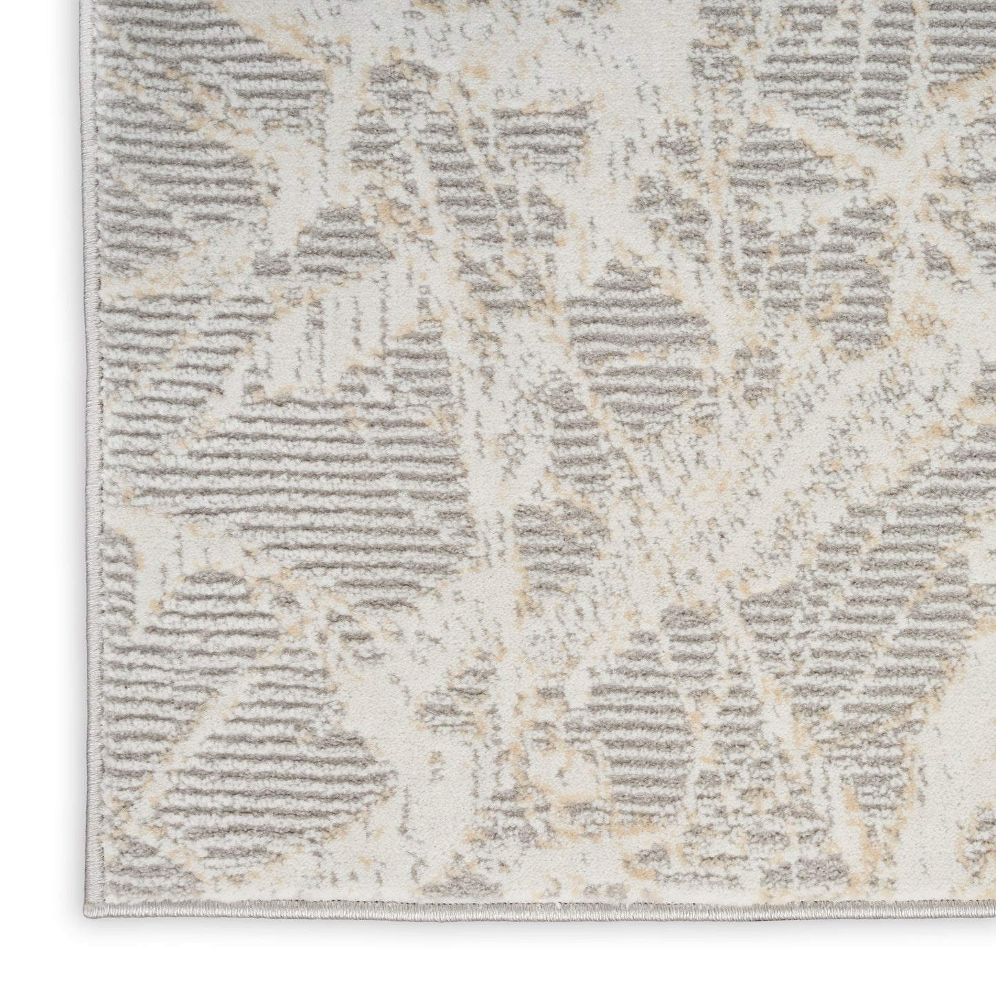 Beige and gray abstract geometric rug with plush pile and light edge binding.