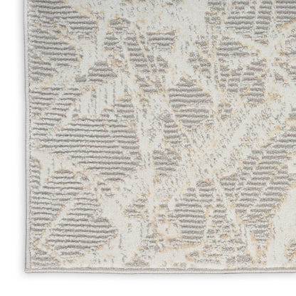 Beige and gray abstract geometric rug with plush pile and light edge binding.