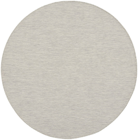 Round beige-gray woven rug with subtle textured weave.