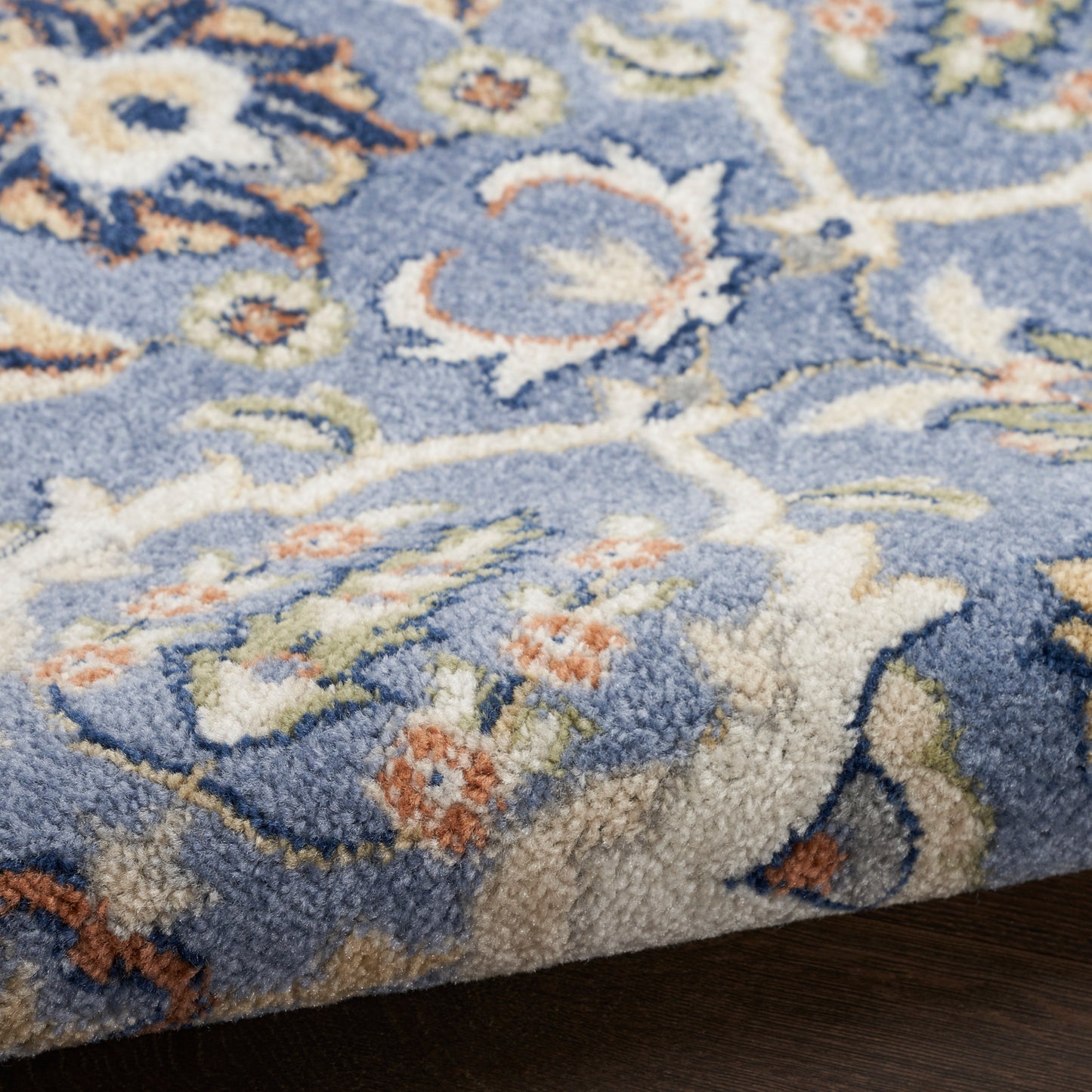 Blue floral Bohemian area rug with cream and peach accents; plush woven pile for classic home decor.
