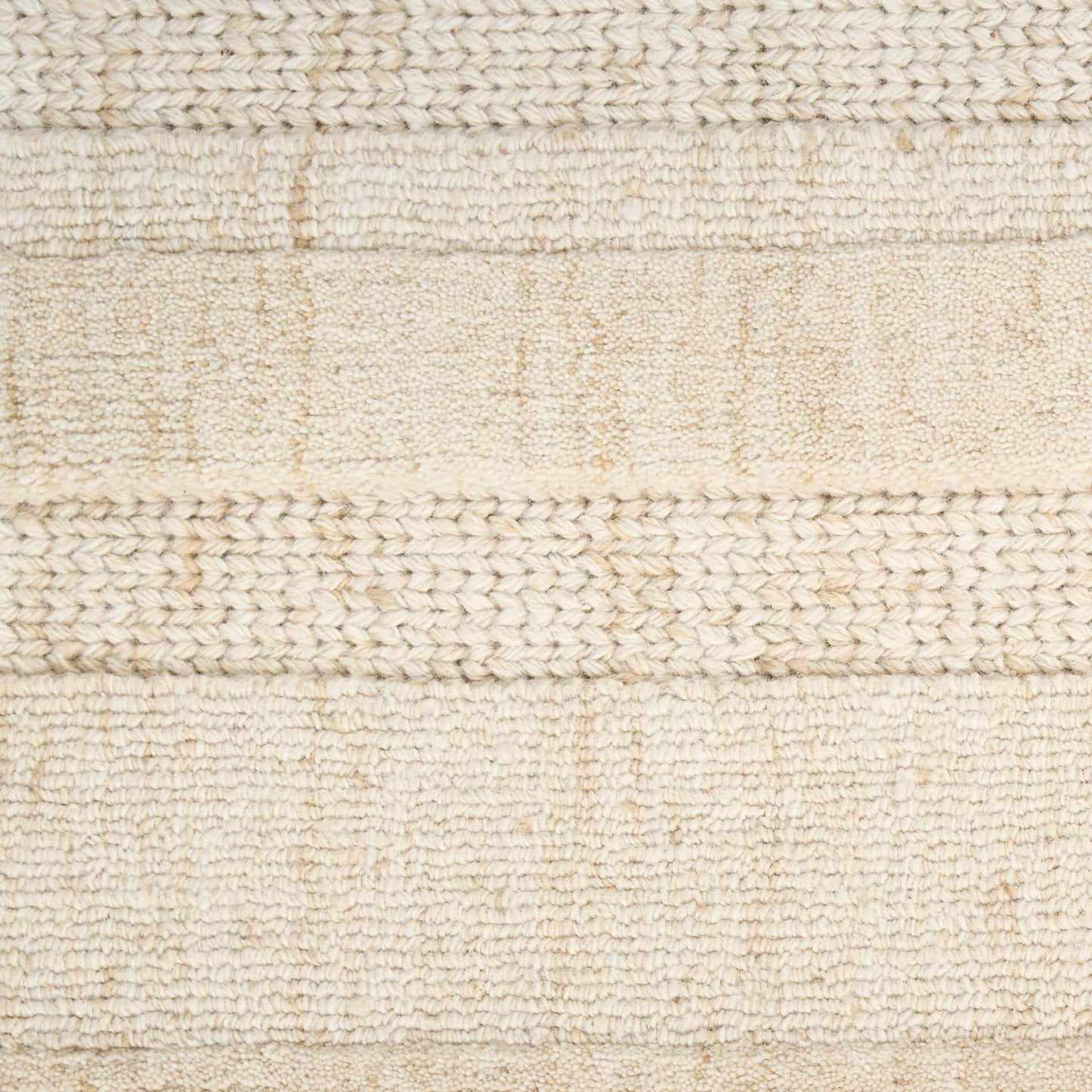 Beige woven rug with varying textured stripes and braided-knit bands.