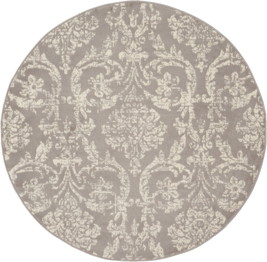 Round taupe rug with cream damask pattern; traditional decorative textile.