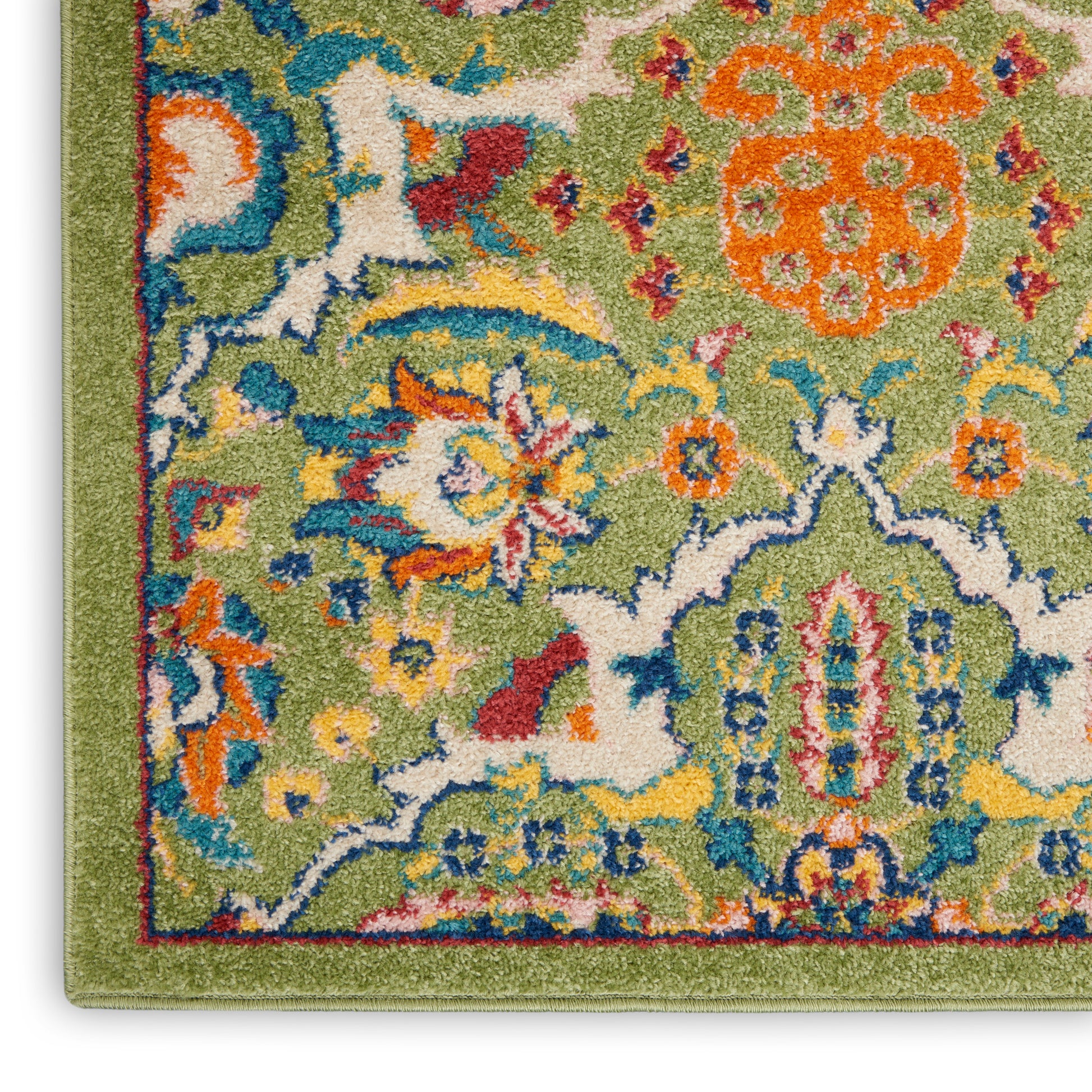 Close-up of a vibrant green runner rug corner with multicolor floral motifs and a matching green border.