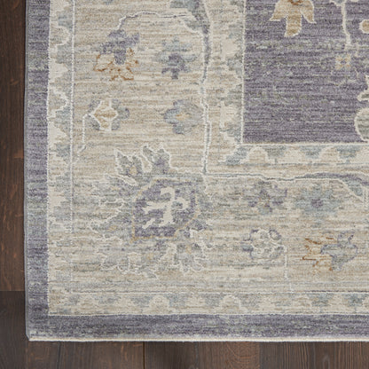 Area rug with ivory field, blue-gray floral motifs and a dark blue border in a vintage Persian-inspired pattern.