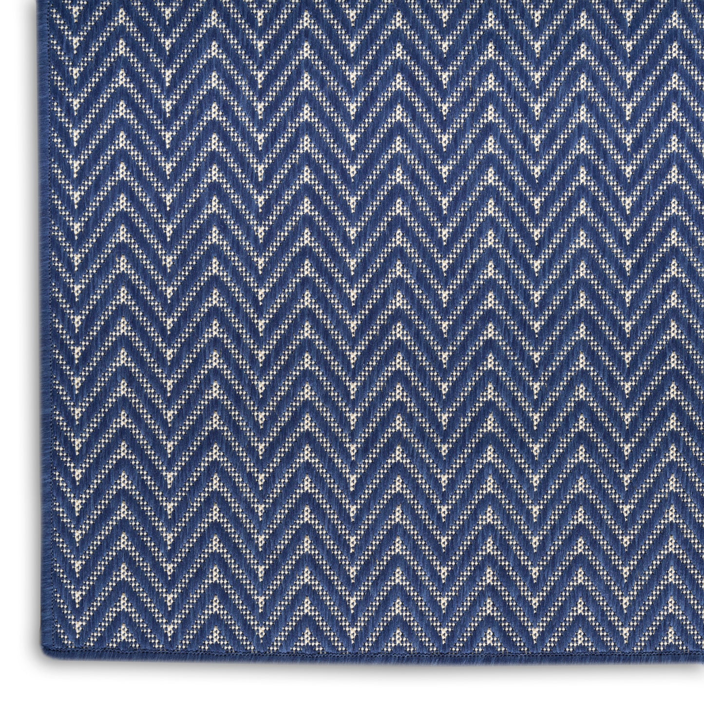 Close-up of navy and light blue chevron zigzag woven fabric, textured with alternating light and dark blue threads.