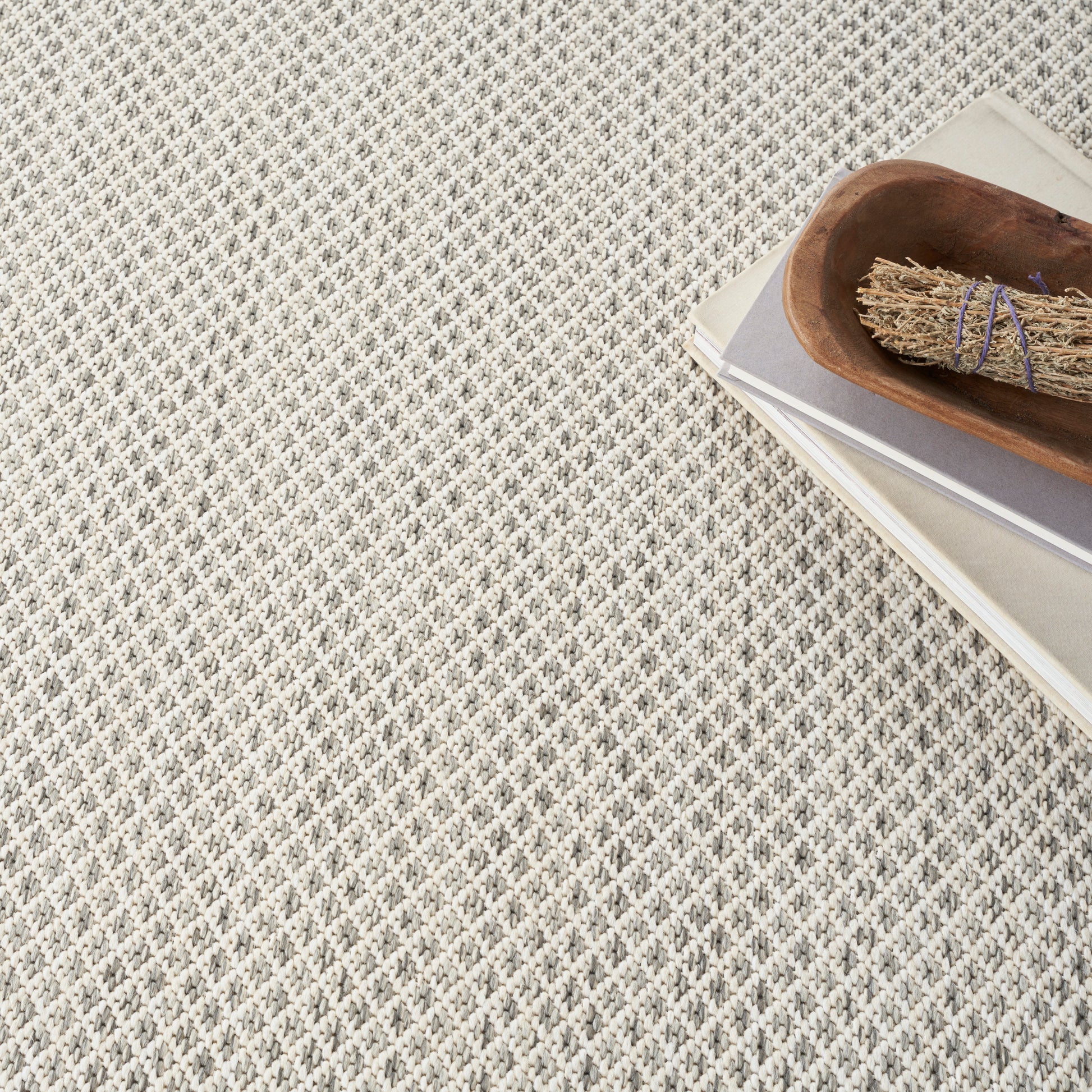 Beige rectangular card stock with smooth matte finish on textured woven fabric background.