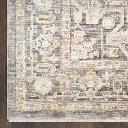 Traditional oriental-style runner rug in gray, ivory and pale yellow on a dark wood floor.