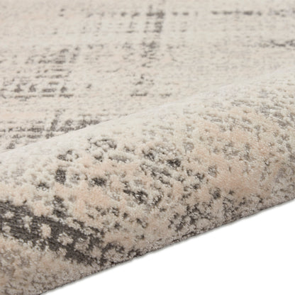 Beige cream and gray abstract patterned area rug with soft plush pile.
