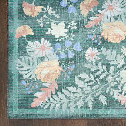 Teal floral area rug with peach and white flowers, lavender accents, woven texture and teal border on wood floor.