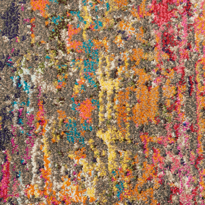 Close-up of a chunky multicolor shag rug with orange, yellow, pink, blue and purple tufts on a gray base.