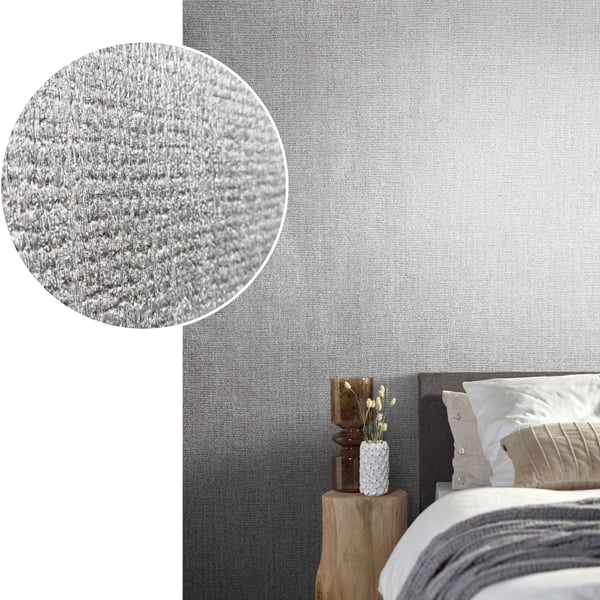 Grey textured wallpaper gradient behind a modern bed with white bedding, beige throw, and a natural wood bedside table.