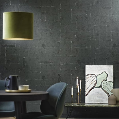 Black abstract wallcovering with a graphic pattern on a textured wall.
