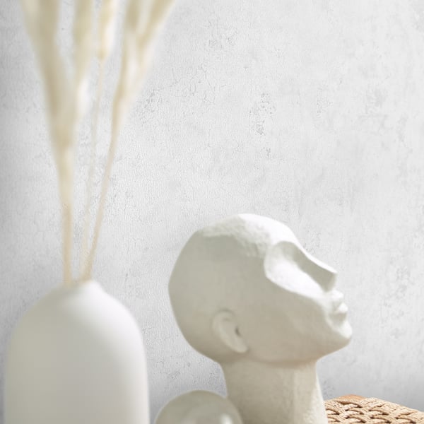White wallpaper with a subtle neutral texture.