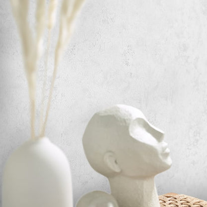 White wallpaper with a subtle neutral texture.