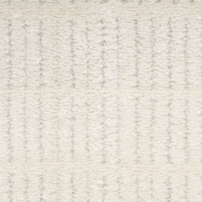 Cream rug with raised vertical ribbed stripes and soft plush pile.