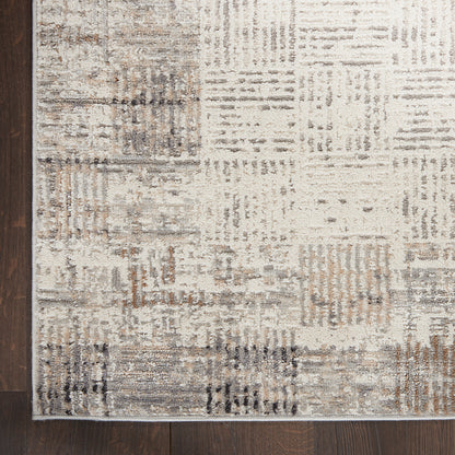 Neutral patchwork area rug with beige, gray, taupe squares; slim border, modern abstract style for living rooms.