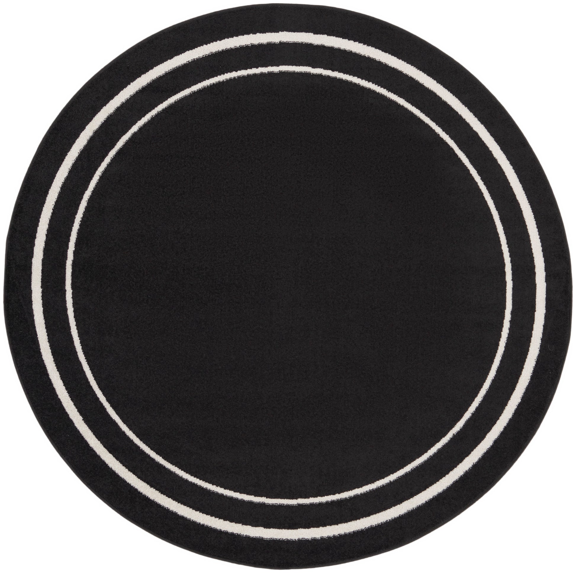 Round black rug with two white circular bands.
