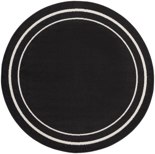 Round black rug with two white circular bands.