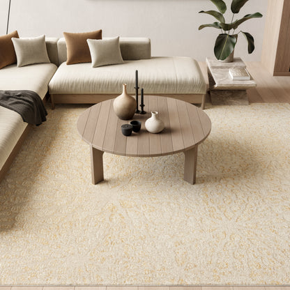 Cream-colored modern rug (8' x 10') in a living room with a round wooden coffee table, ceramic vases and candles, and a beige sectional sofa with taupe cushions.