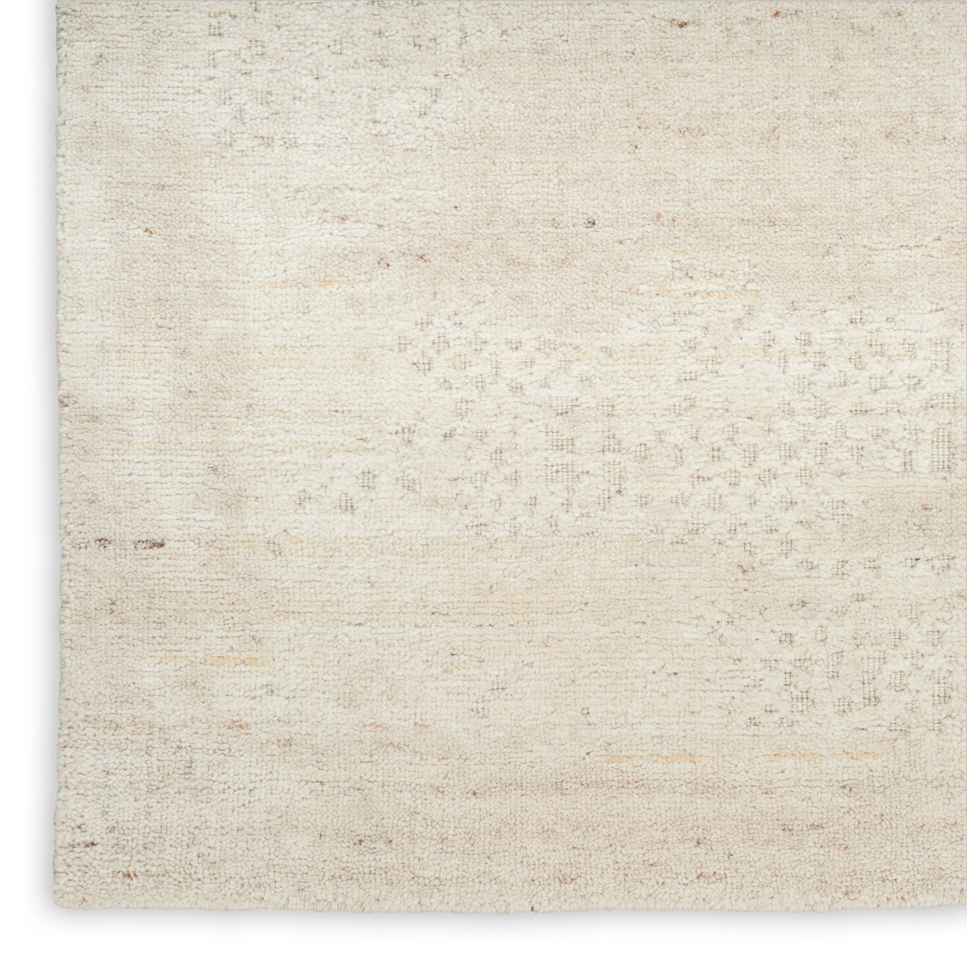 Neutral beige woven rug with a soft textured surface and subtle pattern.