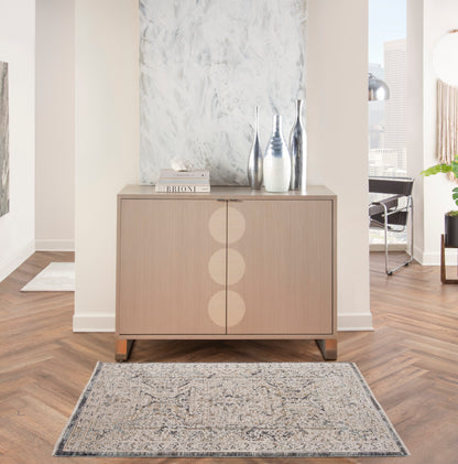 Vintage 3' x 5' rug in light neutral tones with a subtle pattern.