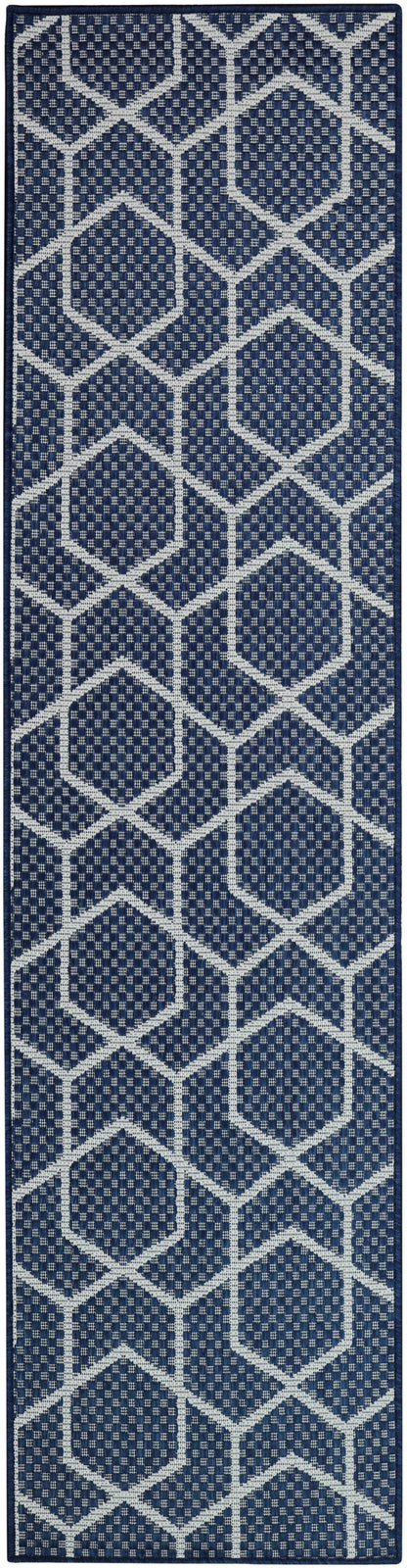 Navy blue runner rug with white geometric hexagon lattice pattern and woven texture.