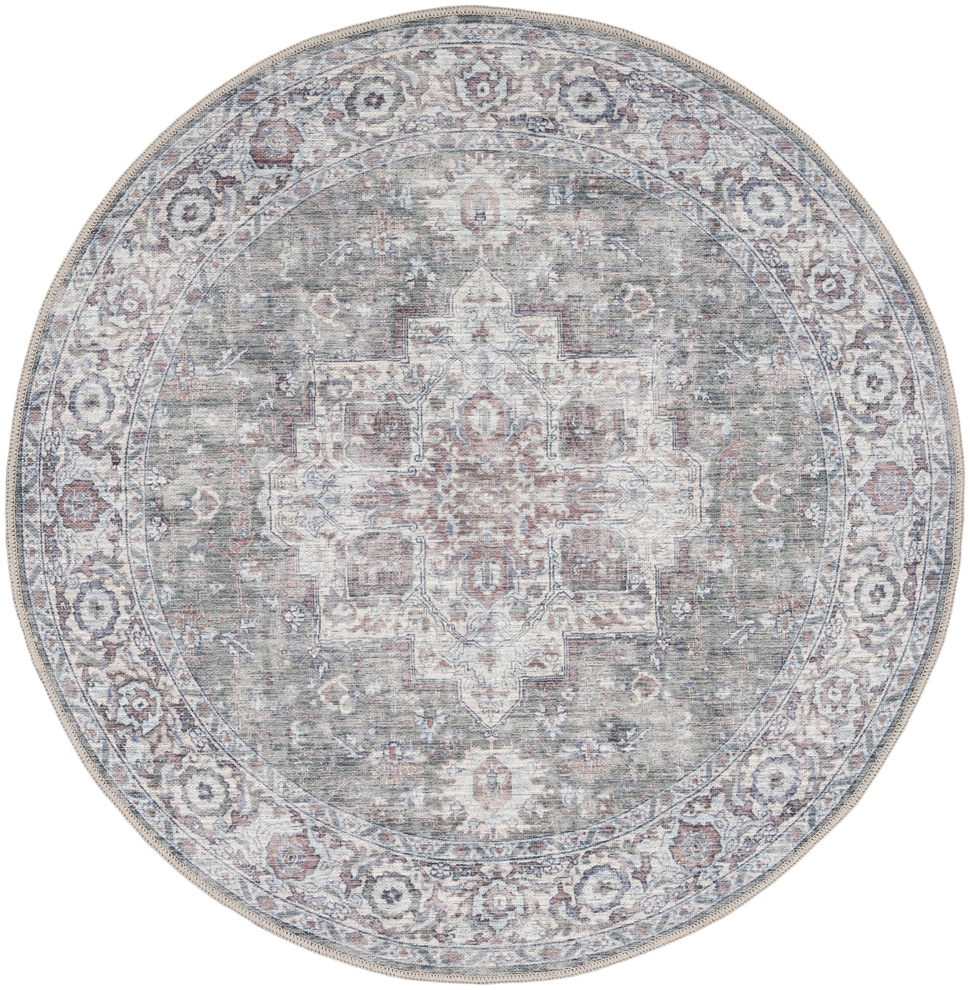 Round oriental rug with distressed medallion center in muted teal-gray, ivory and rose tones, bordered with floral pattern.