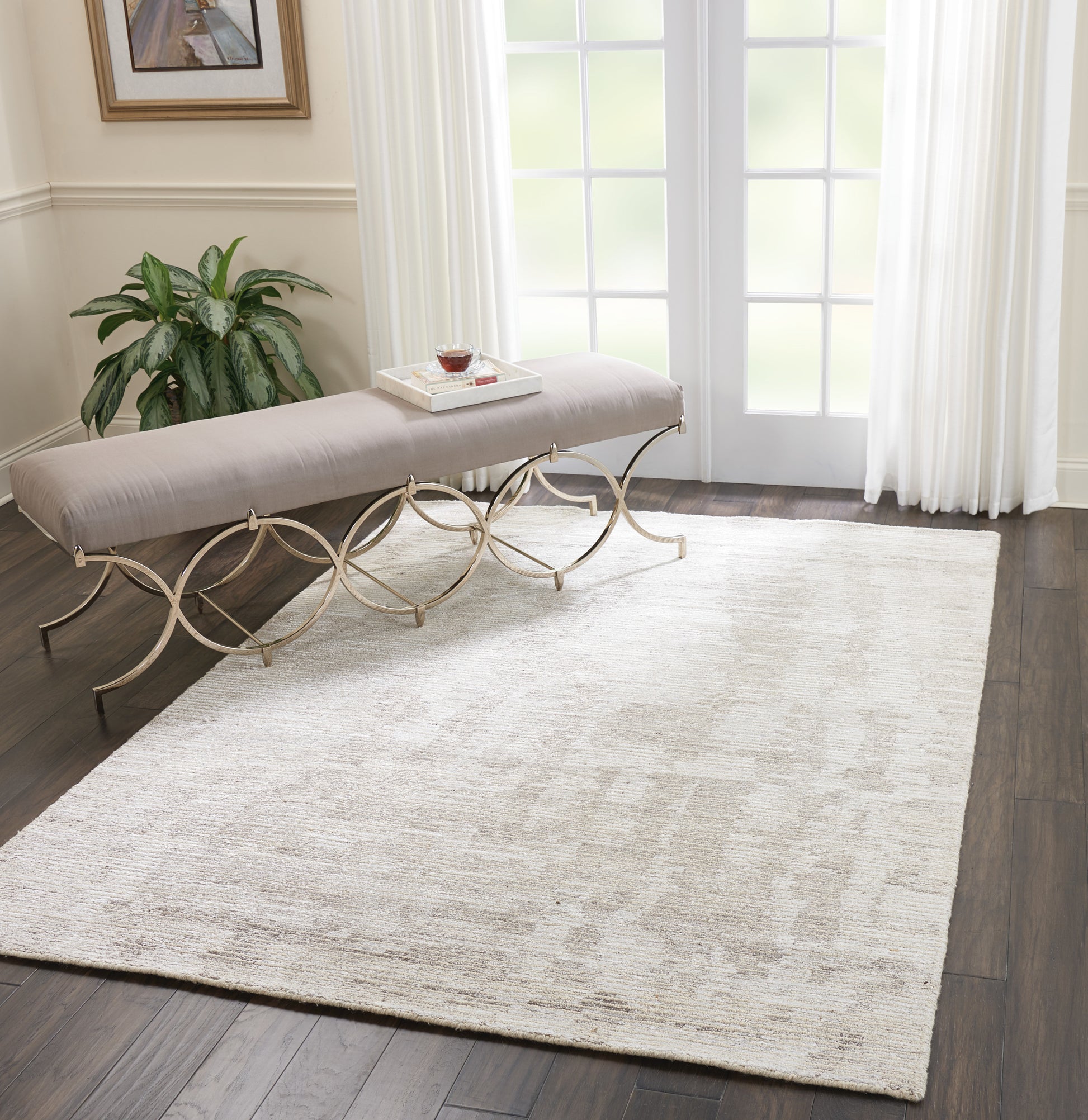 Beige textured rug on dark hardwood floor.