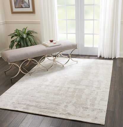 Beige textured rug on dark hardwood floor.