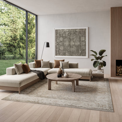 Neutral minimalist living room with beige sectional, round wooden coffee table, abstract art, floor lamp, glass wall.