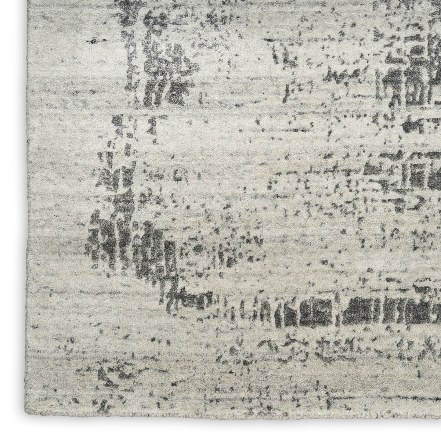 Light gray distressed area rug with an abstract dark pattern; rectangular, soft textured home decor.