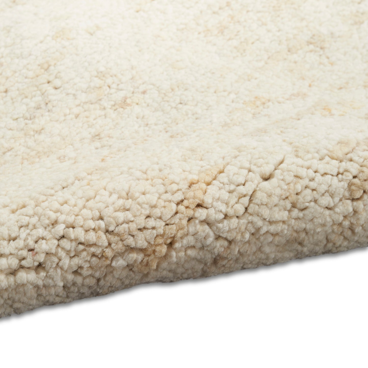 Beige sherpa-style plush rug with rolled edge; soft faux fleece, chunky boucle texture.