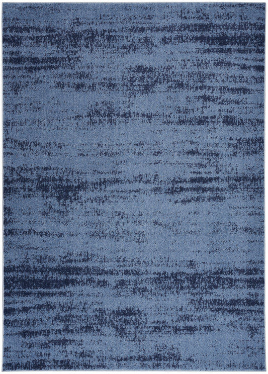 Blue abstract area rug with mottled dark and light blue tones and soft gradient.