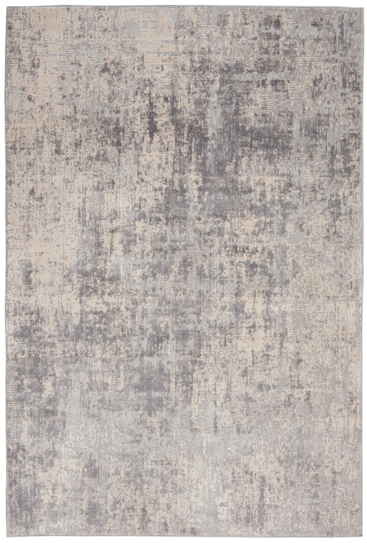 Rectangular area rug with a muted gray and beige distressed abstract pattern; modern, soft-toned.