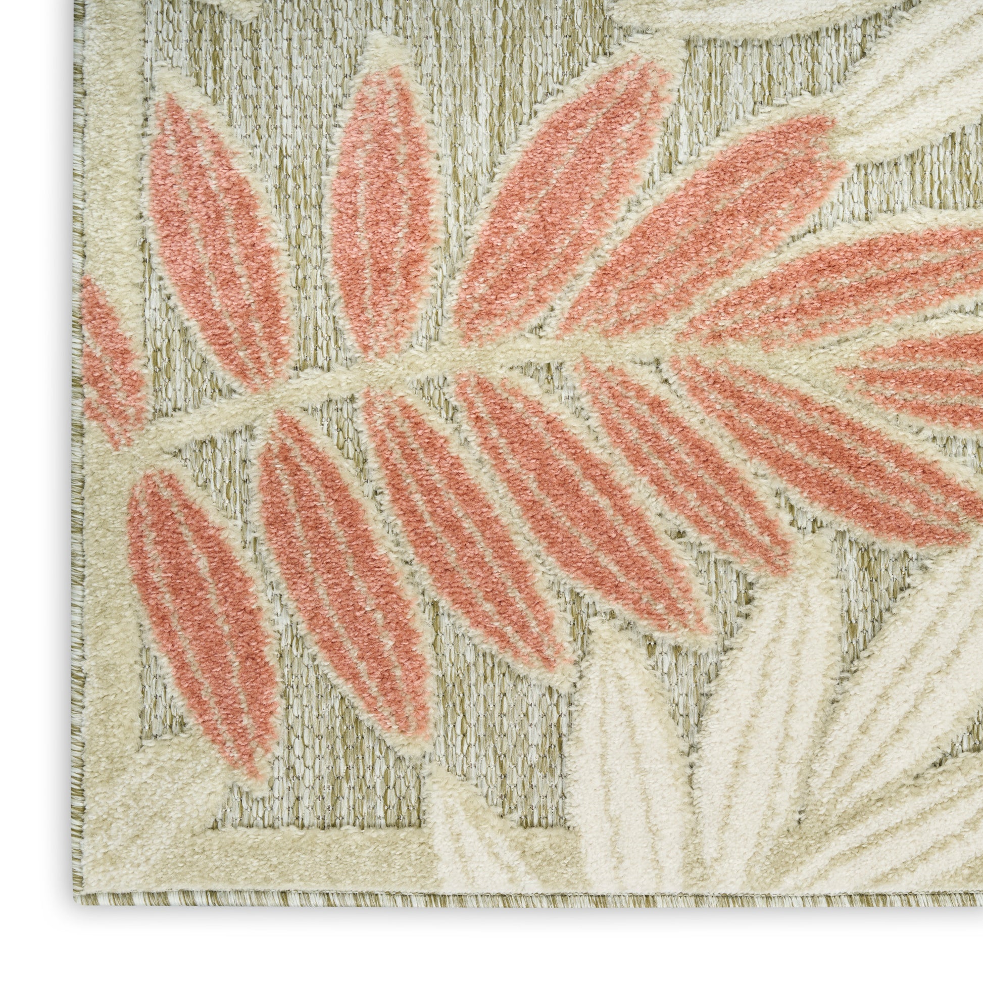 Beige woven rug with coral-pink leaf pattern, botanical motif, soft textile decor for living room.
