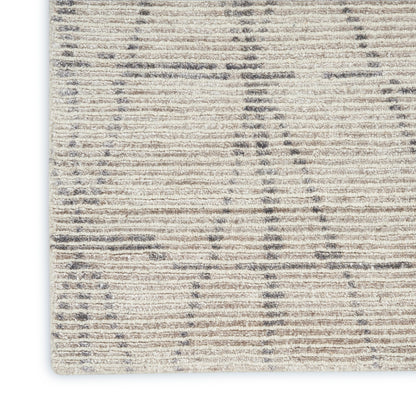 Beige and ivory striped textured area rug with a subtle geometric pattern; close-up corner.