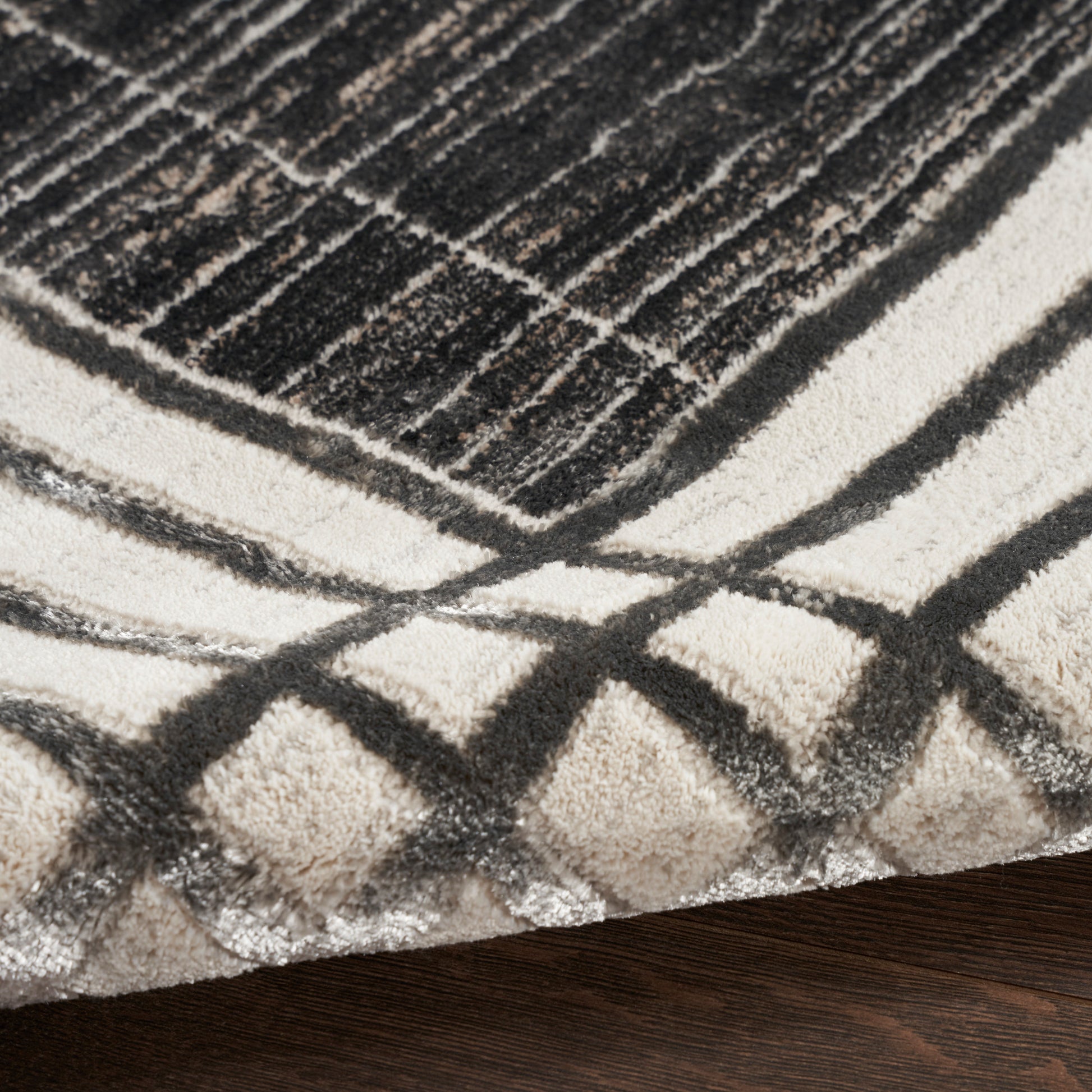 Shaggy geometric area rug in cream, beige and charcoal with bold grid lines for modern living room decor.