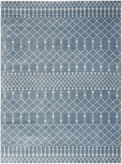 Blue rug with white geometric lattice diamonds and small tassel-like motifs; contemporary decor.