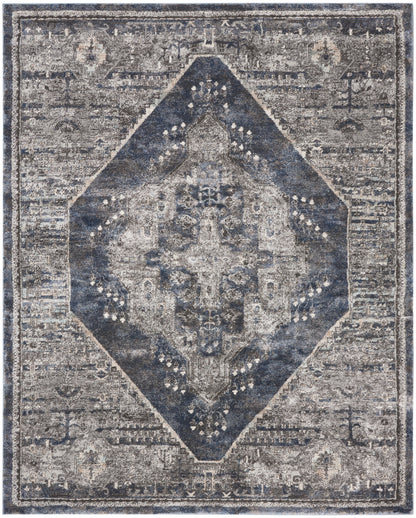 Distressed vintage-style rug with a navy blue diamond medallion on a gray field and faded ornate borders.