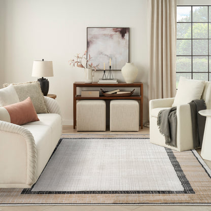 Neutral living room: cream sofa, beige armchair, wooden console, two square ottomans, abstract art, vase, candles, light rug.