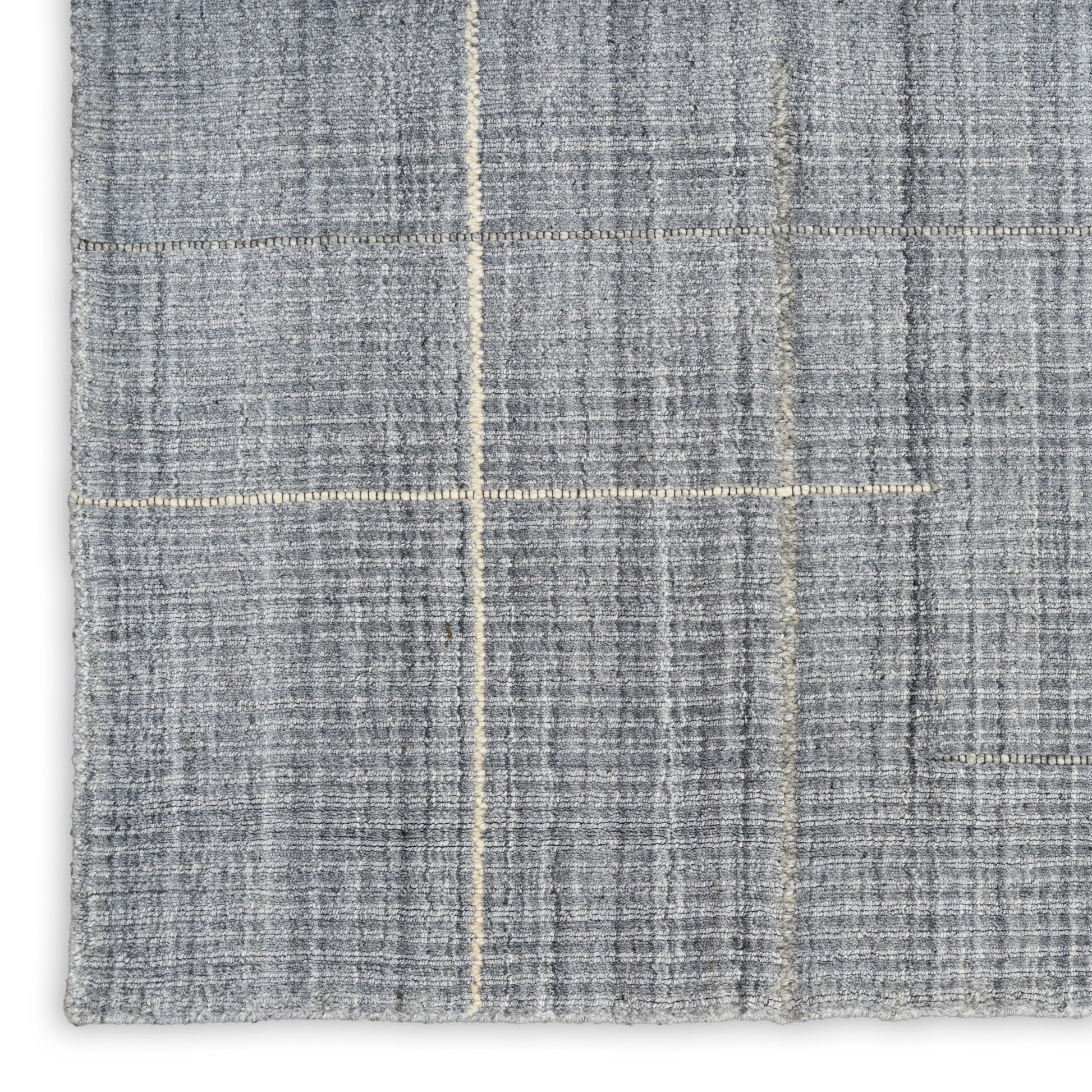 Grey woven rug with subtle beige windowpane plaid lines; close-up texture.