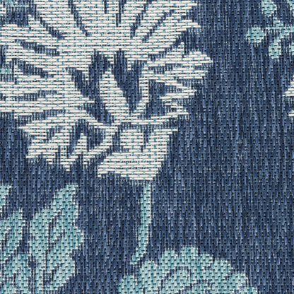 Close-up navy blue woven jacquard fabric with teal floral pattern; textured upholstery textile.