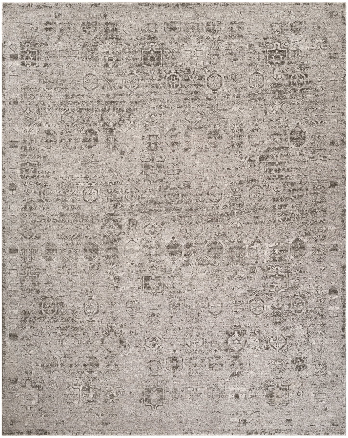 Rectangular beige-gray distressed oriental rug with faded geometric and floral motifs.