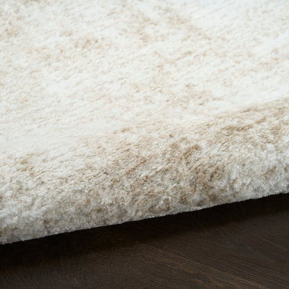 Ivory shag rug with plush, high-pile texture on dark wood floor.